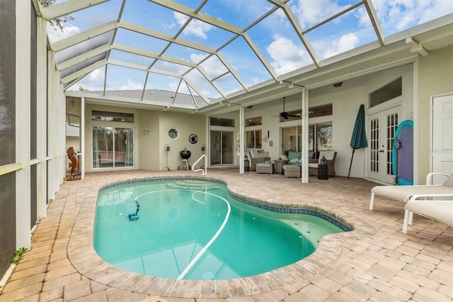 outdoor pool featuring an outdoor hangout area, a patio area, and a lanai