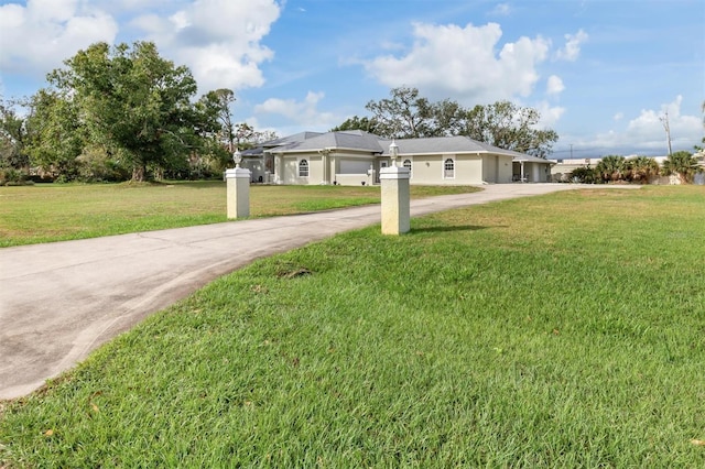 view of front of property with driveway and a front lawn