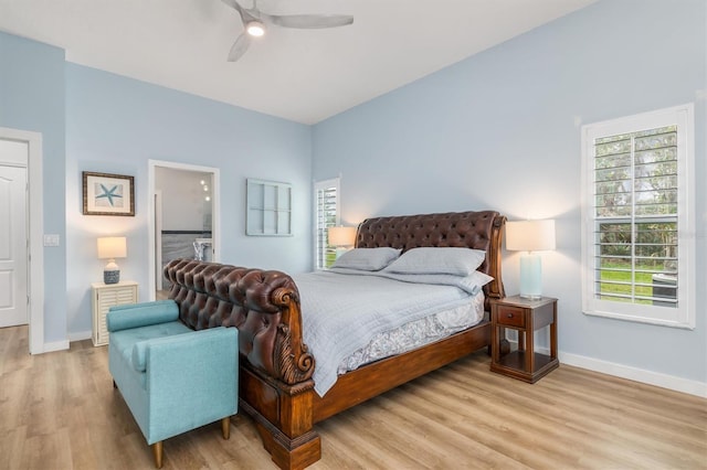 bedroom with connected bathroom, baseboards, ceiling fan, and light wood finished floors