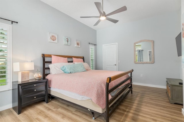 bedroom with ceiling fan, wood finished floors, and baseboards