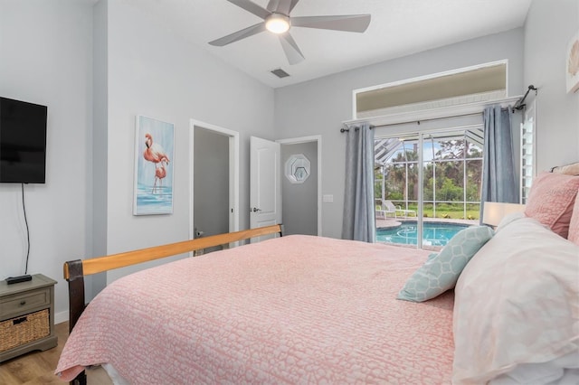 bedroom with access to exterior, visible vents, a sunroom, ceiling fan, and wood finished floors