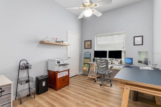 office featuring baseboards, ceiling fan, and light wood finished floors