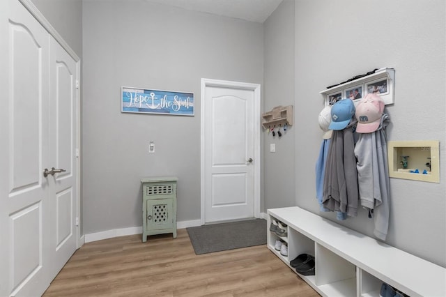 mudroom featuring baseboards and light wood finished floors