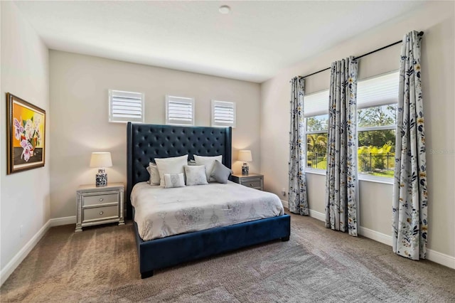 bedroom with dark colored carpet