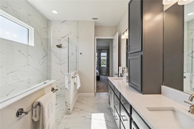 bathroom featuring vanity, plenty of natural light, and a tile shower