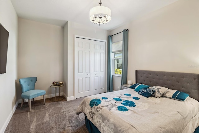 bedroom featuring a notable chandelier, a closet, and carpet flooring