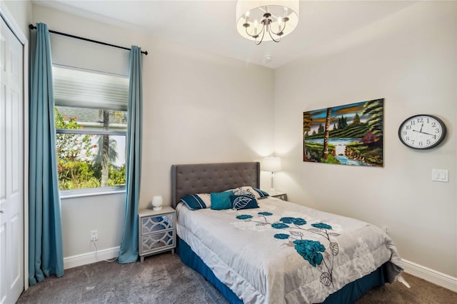 carpeted bedroom with a notable chandelier