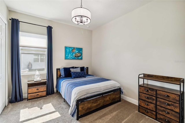 carpeted bedroom with a chandelier