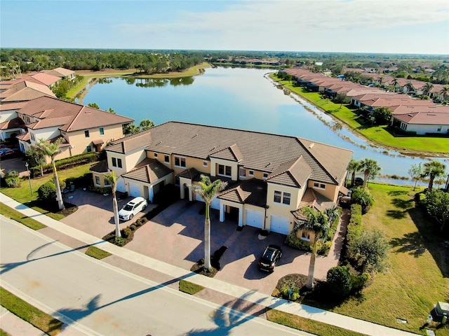 drone / aerial view with a water view and a residential view