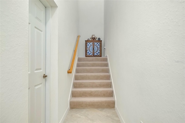 stairway featuring baseboards