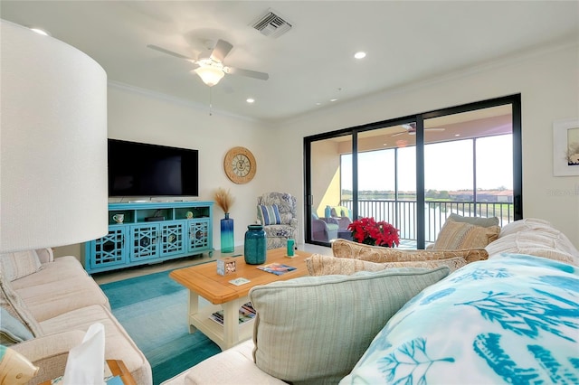 living area featuring ornamental molding, recessed lighting, visible vents, and a ceiling fan