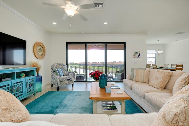 living room with ceiling fan with notable chandelier, ornamental molding, and tile patterned floors