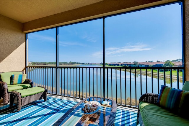 sunroom / solarium with a water view