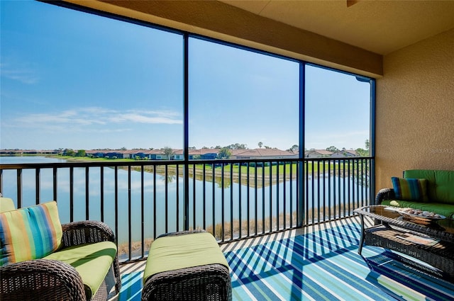 sunroom / solarium featuring a water view