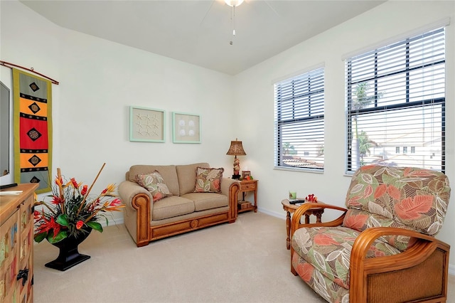 living area with light carpet and baseboards