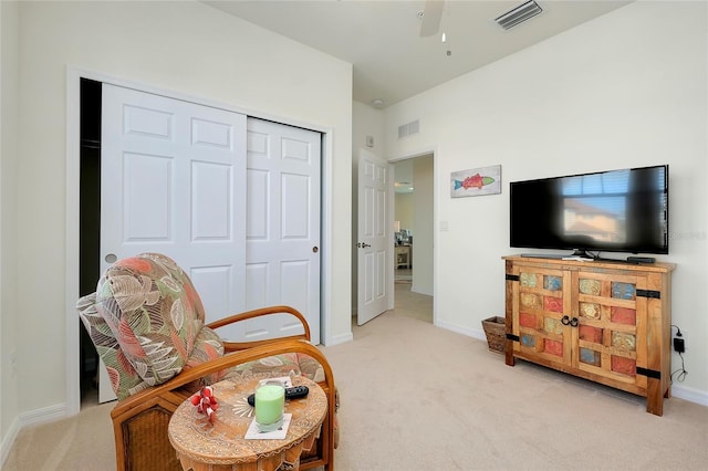 living area featuring light carpet