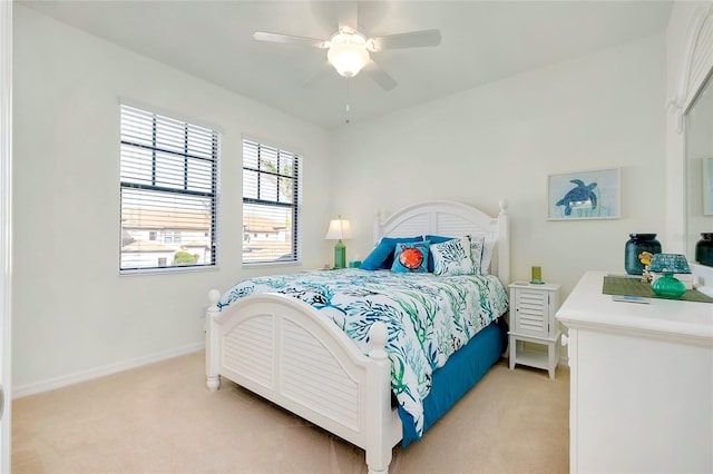 bedroom featuring ceiling fan and light carpet