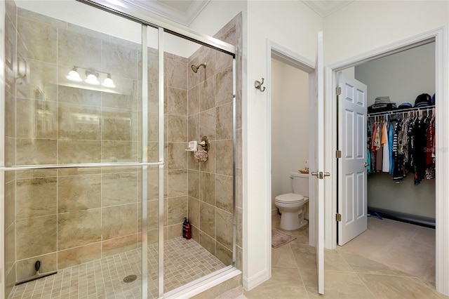 bathroom featuring walk in shower, ornamental molding, tile patterned floors, and toilet