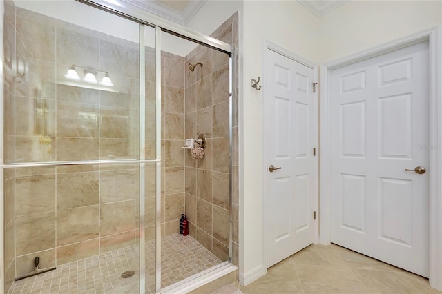 bathroom with crown molding, tile patterned floors, and a shower with shower door