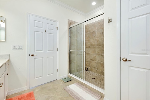 full bath with crown molding, a stall shower, vanity, tile patterned flooring, and baseboards