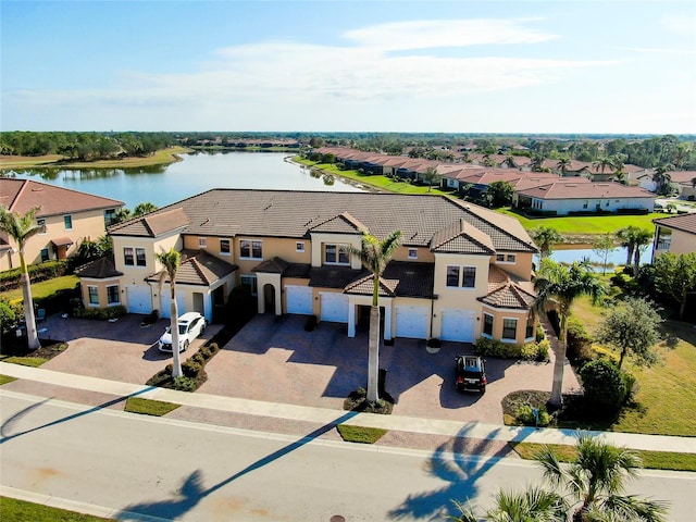 birds eye view of property with a water view and a residential view