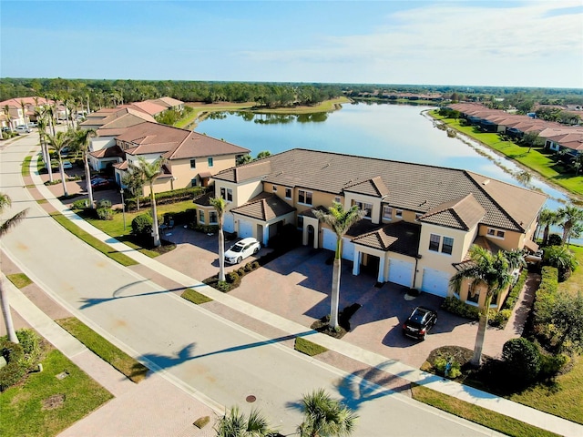 birds eye view of property with a water view and a residential view