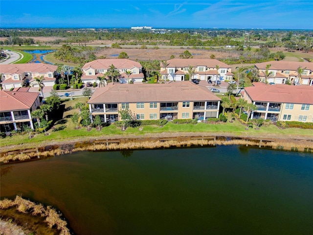 bird's eye view featuring a water view and a residential view