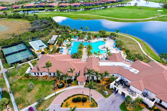 aerial view with view of golf course, a water view, and a residential view