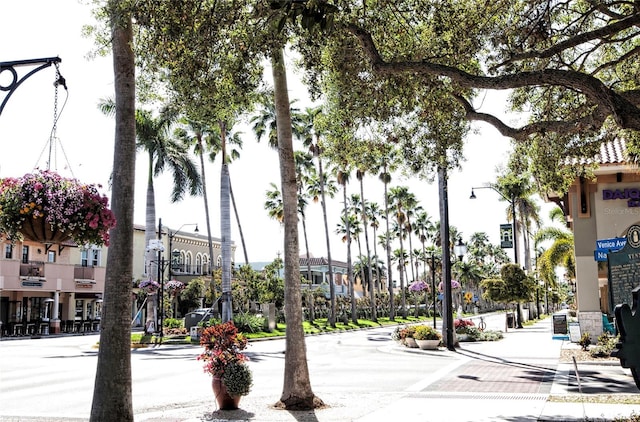 exterior space featuring street lighting, a residential view, curbs, and sidewalks