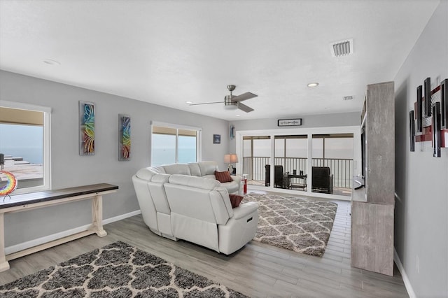 living room featuring light hardwood / wood-style floors and ceiling fan