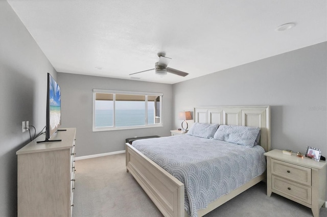 bedroom featuring light colored carpet and ceiling fan