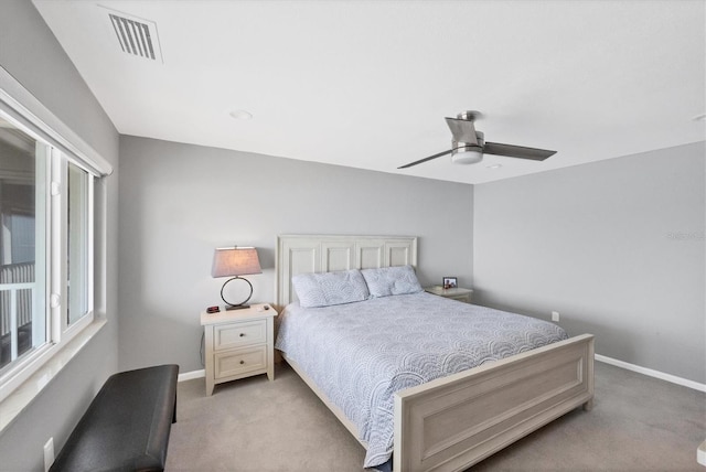 bedroom featuring light carpet and ceiling fan