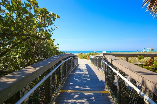 view of home's community featuring a water view and a view of the beach