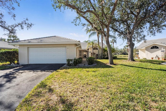 ranch-style home featuring a garage and a front yard