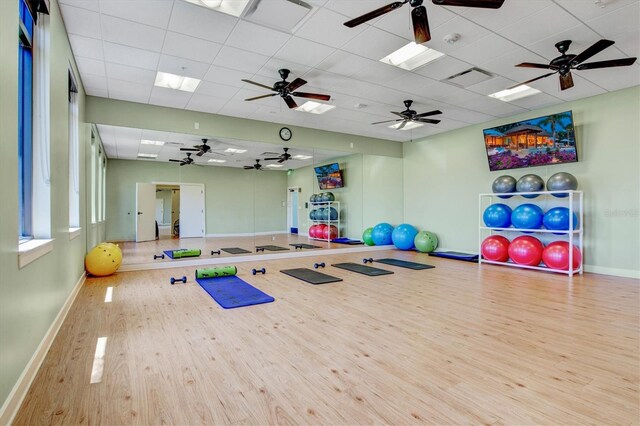 10466 Medjool Dr, Venice, FL 34293 - exercise area with a paneled ceiling, baseboards, ceiling fan, and wood finished floors