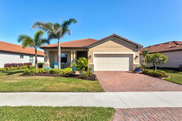 10466 Medjool Dr, Venice, FL 34293 - view of front of property featuring decorative driveway, a front yard, stucco siding, and a garage