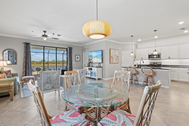 10466 Medjool Dr, Venice, FL 34293 - dining area featuring visible vents, crown molding, baseboards, recessed lighting, and a ceiling fan