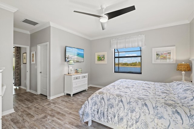 10466 Medjool Dr, Venice, FL 34293 - bedroom featuring visible vents, crown molding, baseboards, wood finished floors, and a ceiling fan