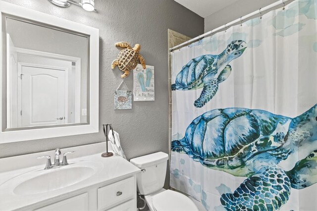 10466 Medjool Dr, Venice, FL 34293 - full bath featuring curtained shower, a textured wall, toilet, and vanity