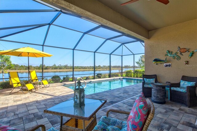 10466 Medjool Dr, Venice, FL 34293 - pool featuring glass enclosure, a water view, a patio, and a ceiling fan