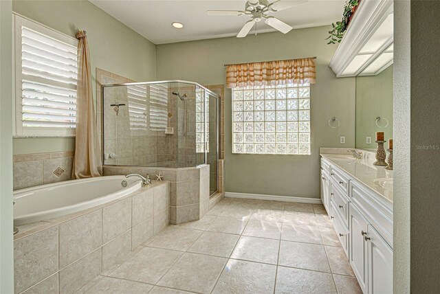 408 Otter Creek Dr, Venice, FL 34292 - bathroom featuring a shower stall, a ceiling fan, a garden tub, double vanity, and tile patterned flooring