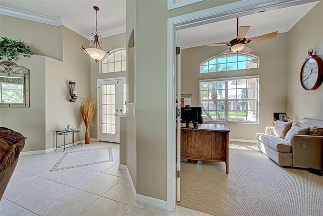 408 Otter Creek Dr, Venice, FL 34292 - entrance foyer featuring baseboards, a ceiling fan, crown molding, light tile patterned floors, and a high ceiling