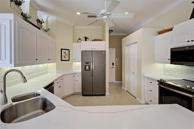 408 Otter Creek Dr, Venice, FL 34292 - kitchen with appliances with stainless steel finishes, a sink, light stone countertops, crown molding, and a ceiling fan