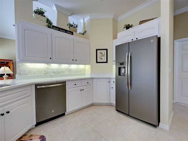 408 Otter Creek Dr, Venice, FL 34292 - kitchen with stainless steel appliances, ornamental molding, decorative backsplash, white cabinetry, and light countertops