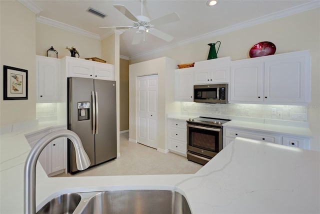 408 Otter Creek Dr, Venice, FL 34292 - kitchen featuring stainless steel appliances, light stone countertops, ornamental molding, decorative backsplash, and white cabinets