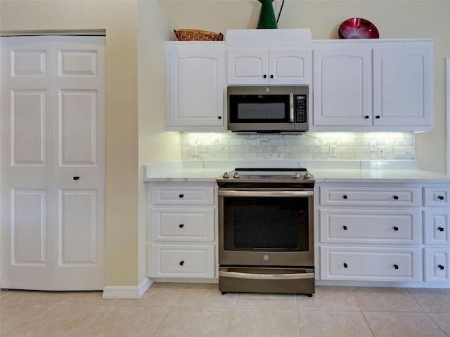 408 Otter Creek Dr, Venice, FL 34292 - kitchen featuring stainless steel appliances, light countertops, tasteful backsplash, and light tile patterned flooring