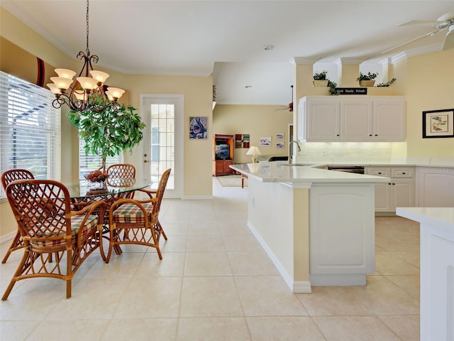 408 Otter Creek Dr, Venice, FL 34292 - kitchen with a ceiling fan, a peninsula, light countertops, and light tile patterned floors
