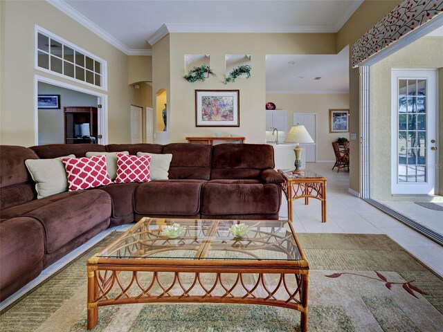 408 Otter Creek Dr, Venice, FL 34292 - living room featuring ornamental molding, light tile patterned flooring, arched walkways, and baseboards