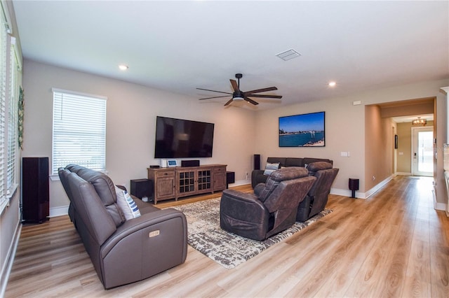 living room featuring ceiling fan and light wood-type flooring