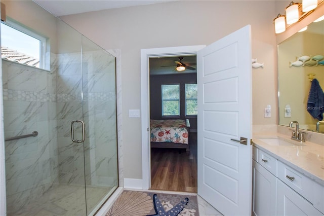 bathroom featuring vanity, a wealth of natural light, and a shower with shower door